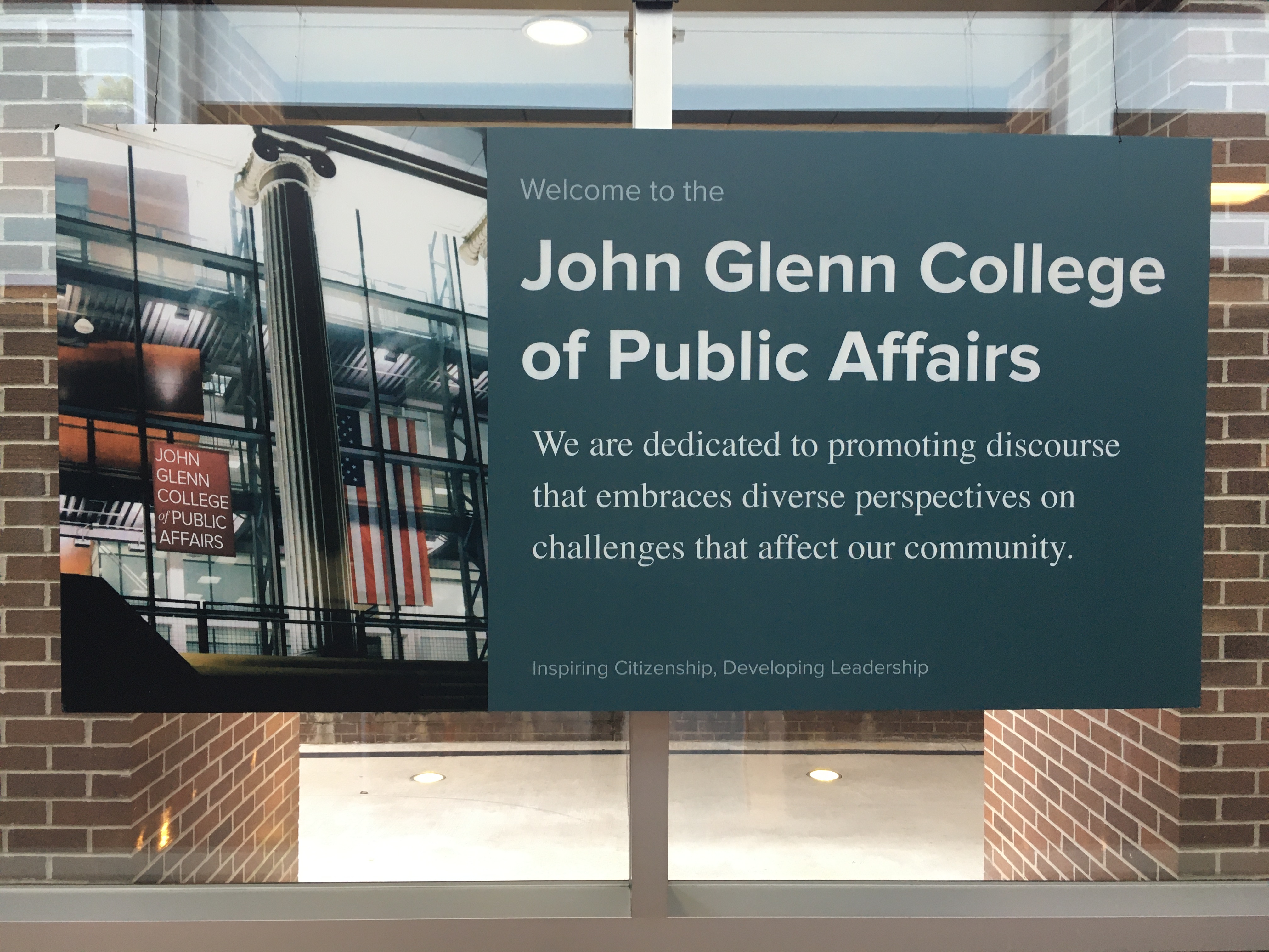 Glenn College welcome sign with the text "We are dedicated to promoting discourse that embraces diverse perspectives on challenges that affect our community."