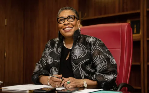 Secretary Marcia L Fudge sitting at desk