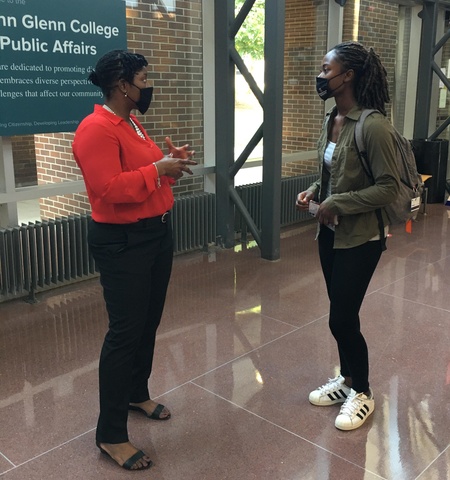 Tina Pierce talking to a student in Page Hall