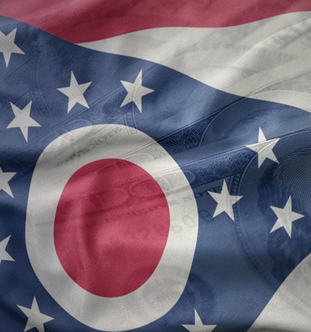 Ohio flag with dollar bill, ohio economic reporting