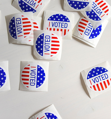 red, white and blue round “I voted” stickers on a white surface (photo by Element5 Digital on Unsplash)