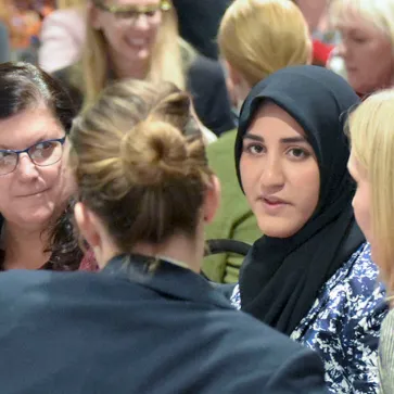 multiple women speak in a group