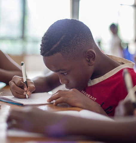 Young Black boy takes test in classroom