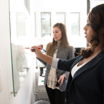 two women at a whiteboard