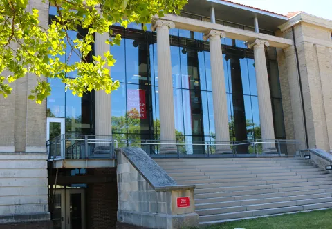 The front steps of page hall and a tree.