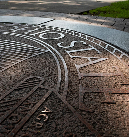 The Ohio State University seal stamped in concrete on the Oval outside