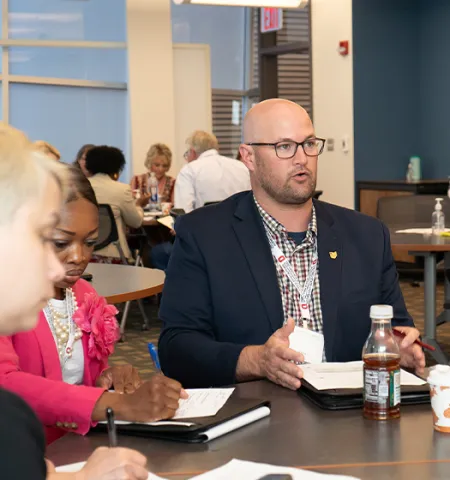 A man speaking at a table.