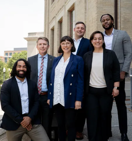 A group of four men and two women - the new college faculty.