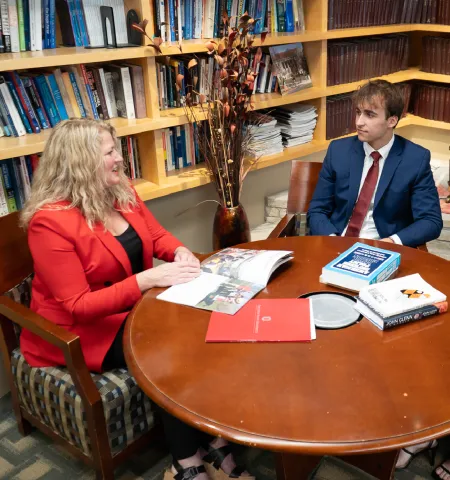 Glenn College graduates sit at a table with the public policy students that received the scholarship, they have a conversation about studying at Ohio State.