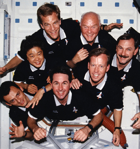 Group portrait of the crew members of NASA mission STS-95 taken while in space aboard the Space Shuttle Discovery, 1998, including Sen. John Glenn, top right
