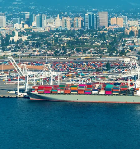 Port of Oakland, California, terminal with cargo ship carrying shipping containers
