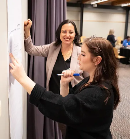 Michelle Moskowitz Brown (left) of the Ohio Food Policy Network and John Glenn College of Public Affairs PhD student Madison Kase discuss ideas for the future of food systems in Ohio.