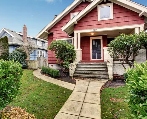 Classic craftsman old American house exterior in red and white (Source: AdobeStock).