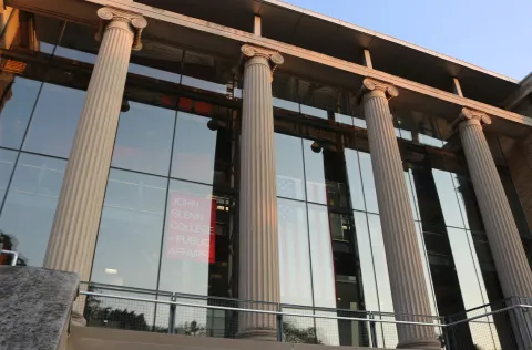 The four pillars at the front of Page Hall during sundown.