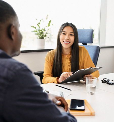 Young woman recruiting employee talking with man during job interview in the office (Credit: AdobeStock.com)