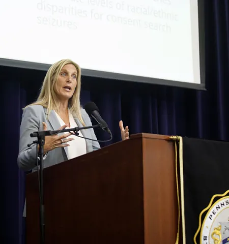 John Glenn College of Public Affairs senior research scientist Robin Engel stands at a lectern on a stage and announces the results of the data analysis at a Pennsylvania State Police press conference. (Credit: Pennsylvania State Police)