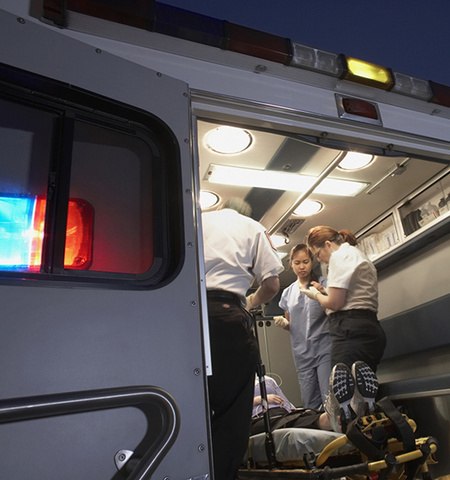 three medical personnel working on a patient in the back of an ambulance (Getty Images)