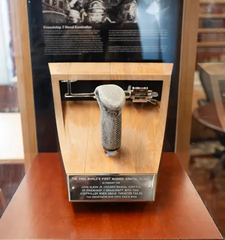 Friendship 7 controller and failed thruster in display case at the John Glenn College of Public Affairs at The Ohio State University