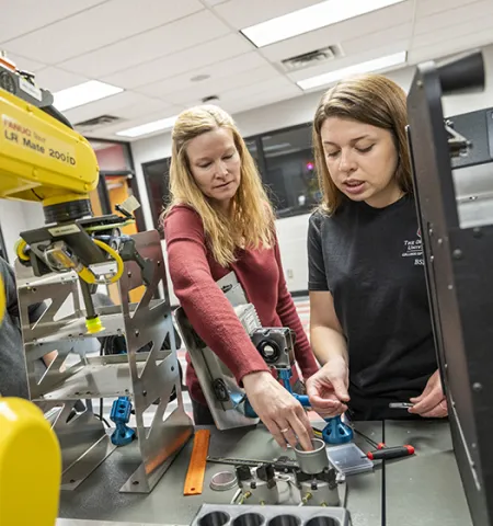 Kendrea Ward, a senior engineering technology student on the Ohio State Mansfield campus, brainstorms necessary changes to the manufacturing system in her Intelligent Manufacturing and Automation class with Assistant Professor Amber Rader.