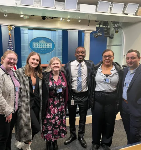  MPA-DC 2023 graduates visited the James S. Brady Press Briefing Room in the West Wing of the White House. From left are Abigail Falcone, Paige Shoemaker DeMio, Glenn College Washington Programs Manager Sarah Holbert, Gabriel Jackson, K'Yalei Harris and Justin Ryan.