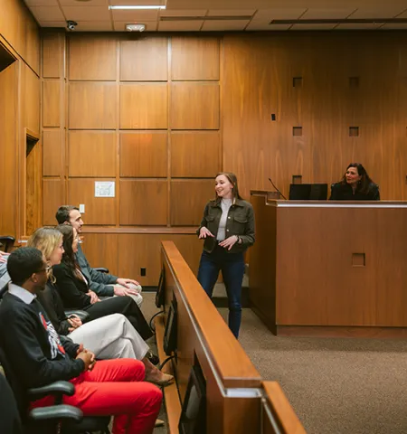 students acting as a jury and attorney in a mock court room with a judge