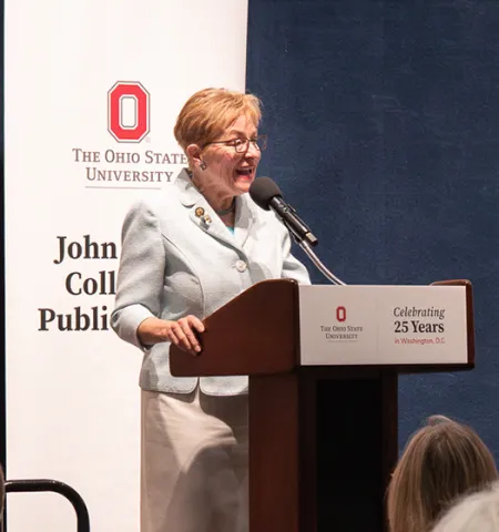 Congresswoman Marcy Kaptur stands at a podium speaking to a crowd during the Excellence in Public Service Award Ceremony, hosted by the John Glenn College of Public Affairs in Washington, D.C.