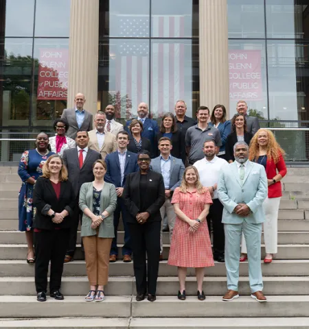 The 2025 Public Leadership Academy Cohort standing on the front steps of Page Hall.