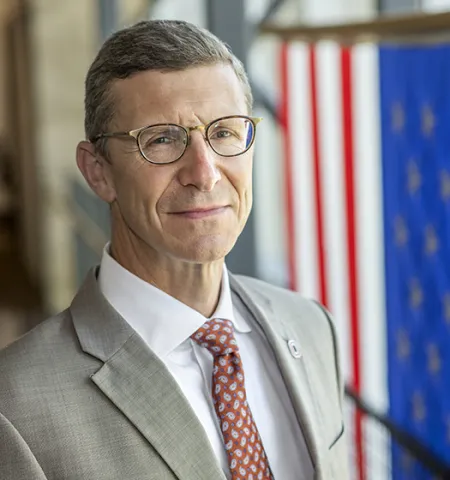 John Glenn College of Public Affairs Dean Trevor Brown stands with an American flag in the background