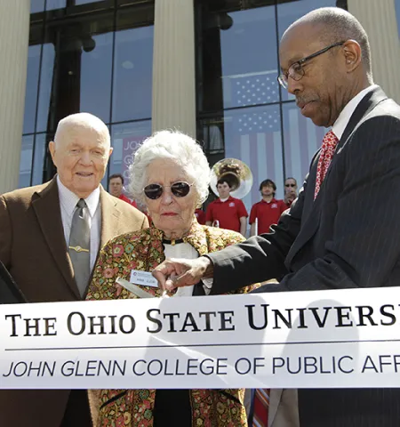 Sen. John and Annie Glenn and then-Ohio State University President Michael V. Drake cut the ribbon for the John Glenn College of Public Affairs in front of Page Hall.