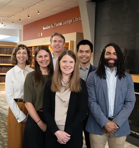 John Glenn College of Public Affairs nonprofit management faculty (from left) Associate Professor Megan LePere-Schloop, Associate Professor Erynn Beaton, Professor Brian Mittendorf, Professor Stephanie Moulton, Assistant Professor Long Tran and Assistant Professor—Provost’s Fellow Greg Wilson stand in front of a fireplace in a library in Page Hall at Ohio State.
