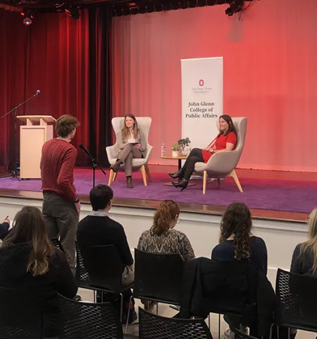 Cleveland Fed President Beth Hammack (right) takes a question from a student as Professor Stephanie Moulton looks on.
