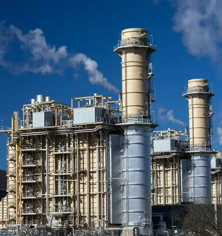 an electricity-generating power plant on a day with a clear blue sky