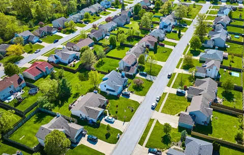 Pristine rows of houses in white collar suburban neighborhood aerial with landscaping and fences
