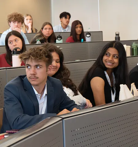 students sit in rows in a classroom listening to a speaker at the John Glenn College of Public Affairs Democracy Camp